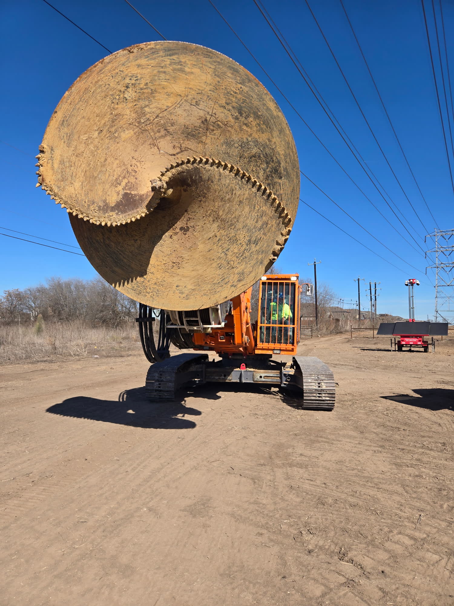 Large diameter auger tool mounted on a drill rig