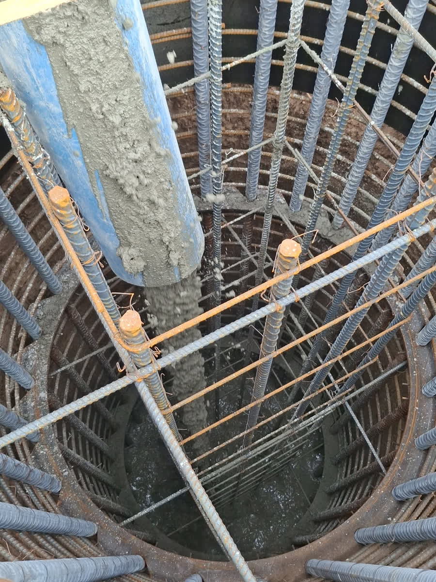 Looking down a caisson with cage and fresh concrete