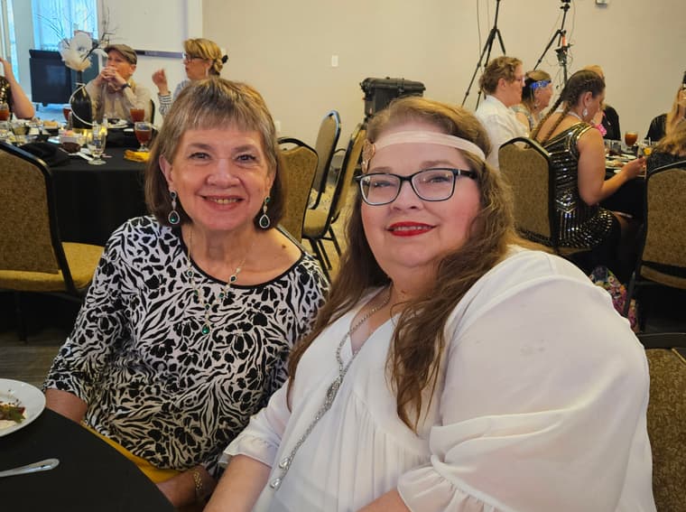 Two members smiling at the convention dinner table
