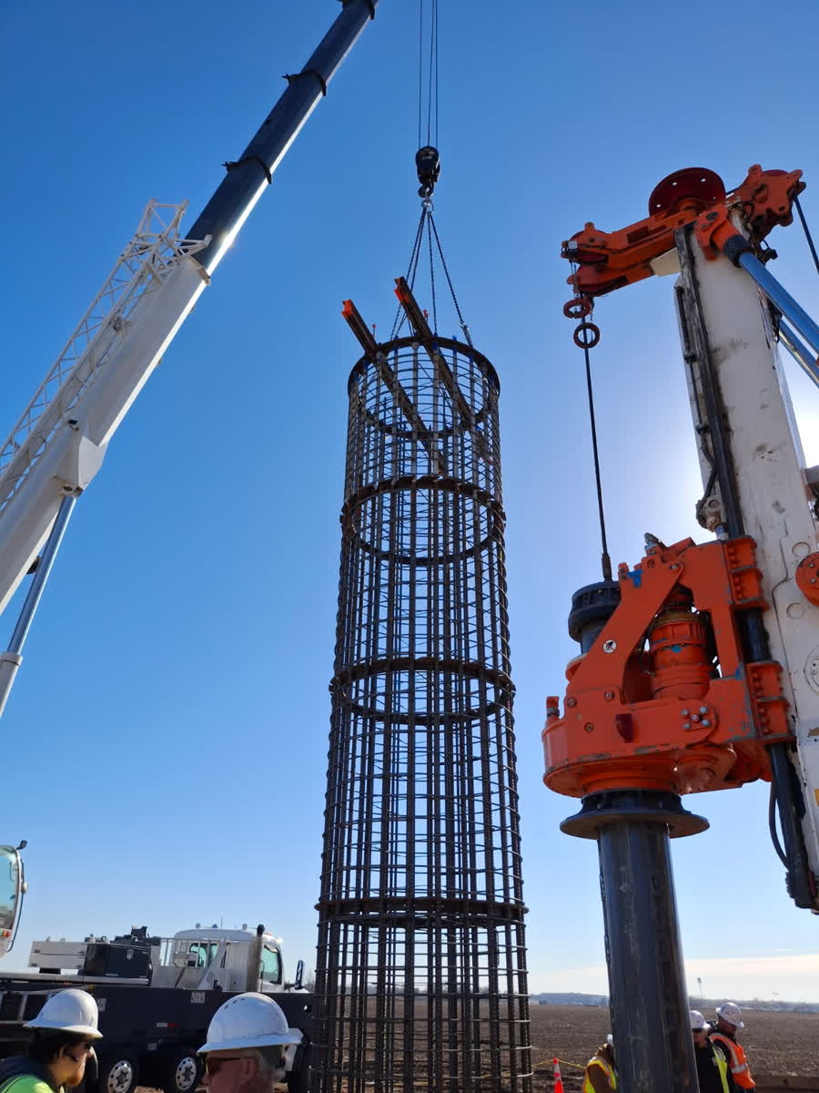 Crane and rig setting a rebar cage together