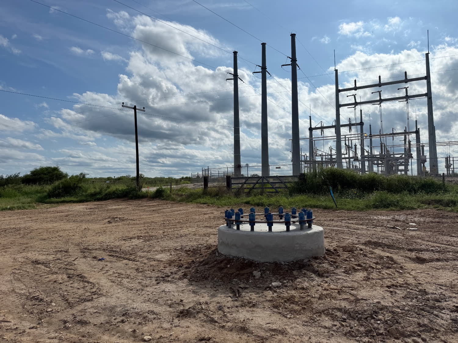 Completed pad foundation in front of an electrical substation