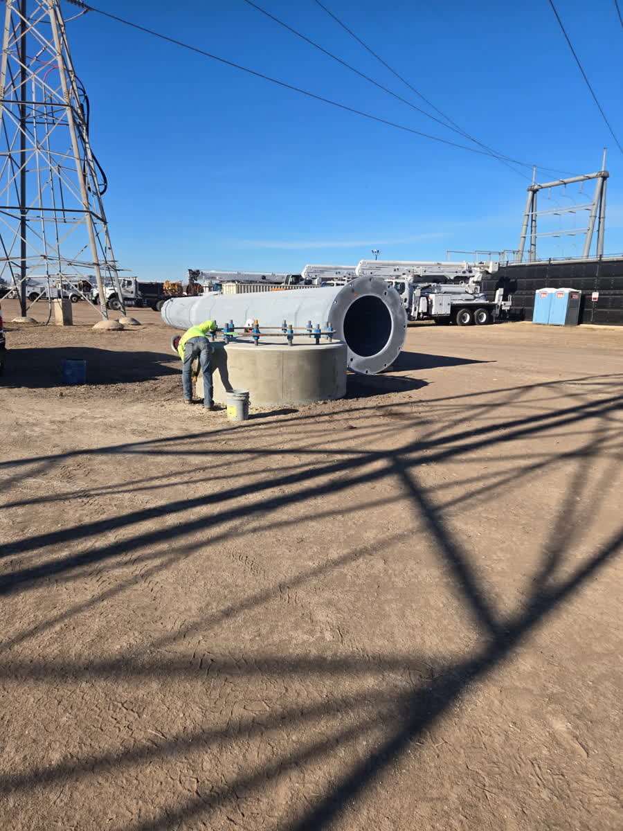 Worker rigging a section of steel casing