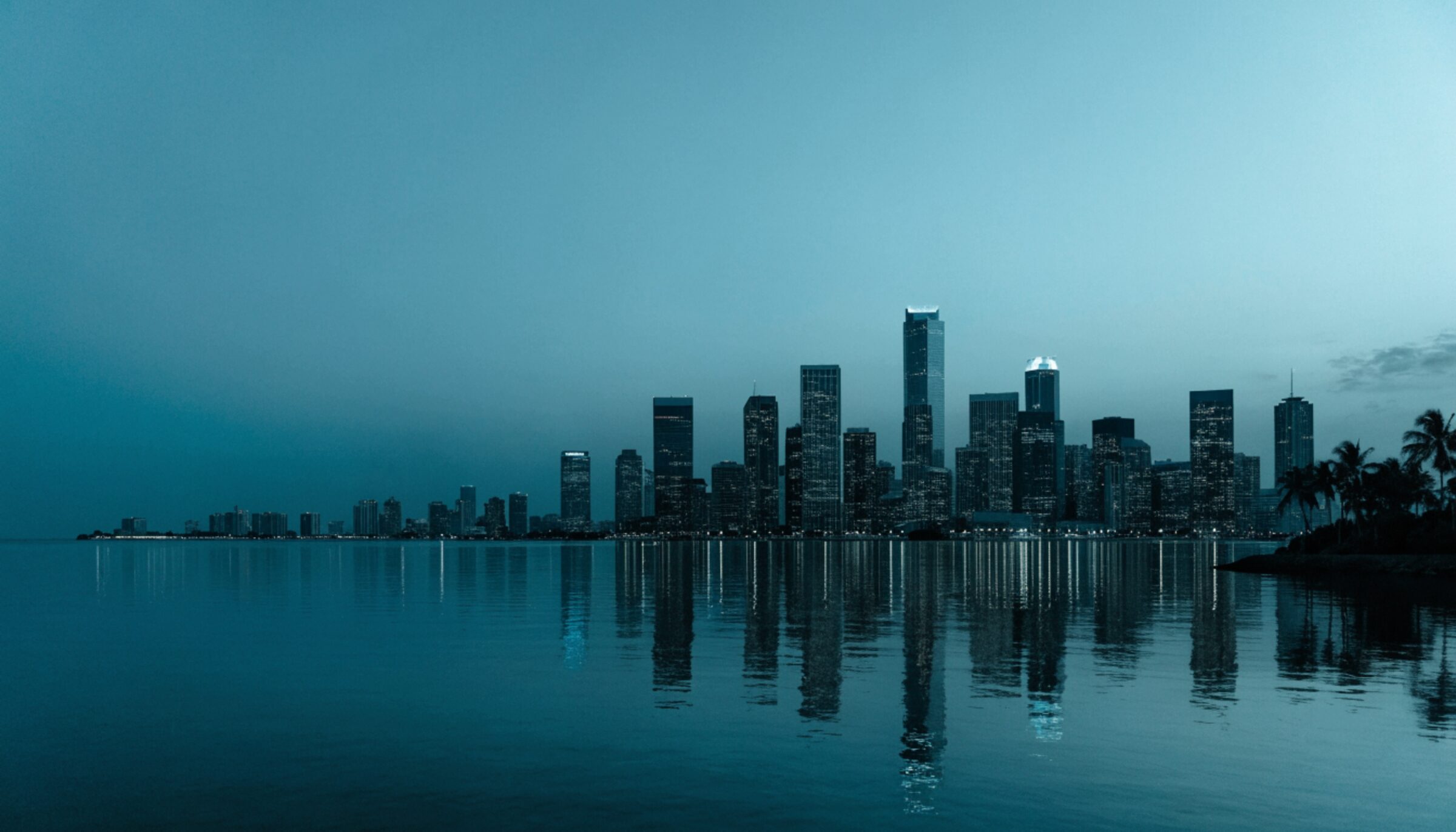 The Miami skyline seen across Biscayne Bay at dusk