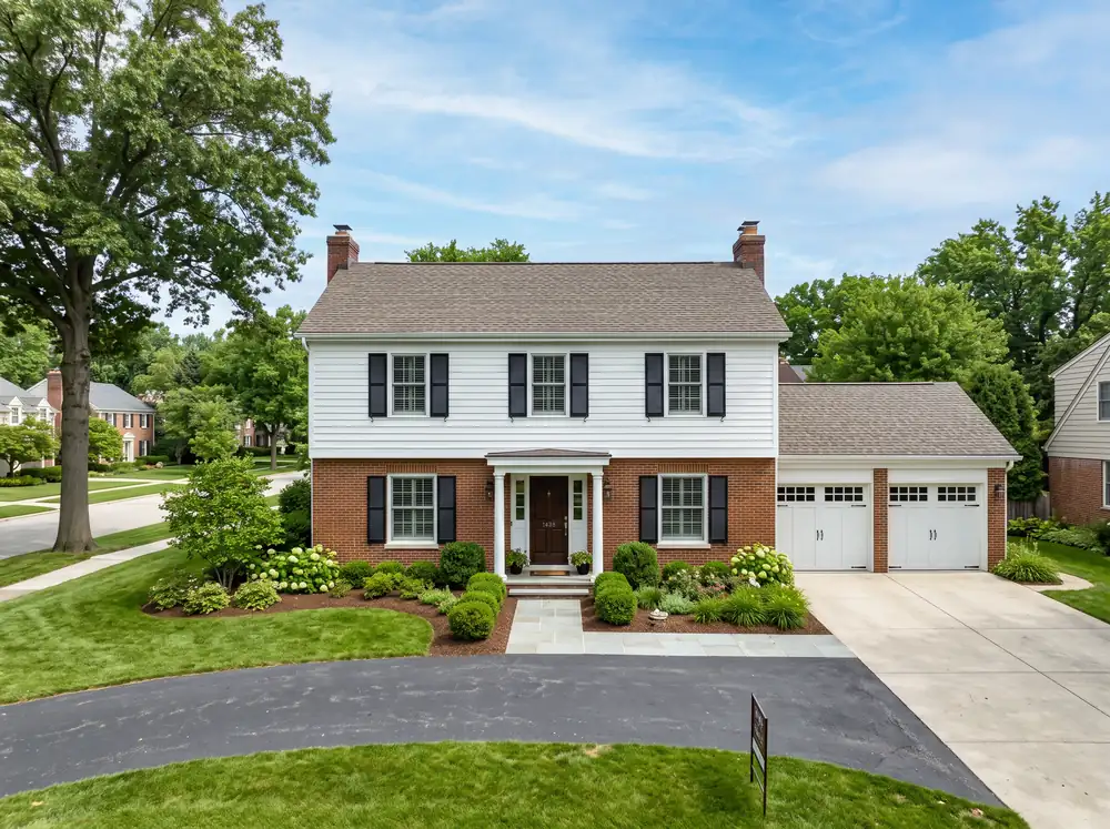 Two-story brick and white colonial single-family home