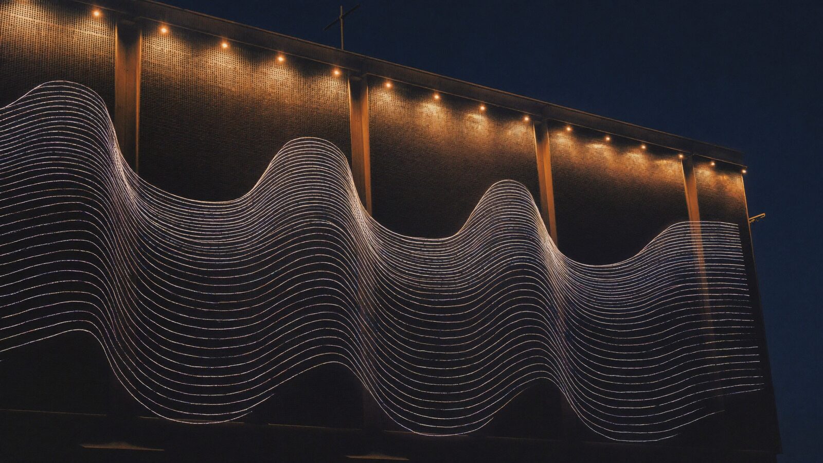 Wall of industrial cooling fans at night with concentric sound-wave rings radiating outward