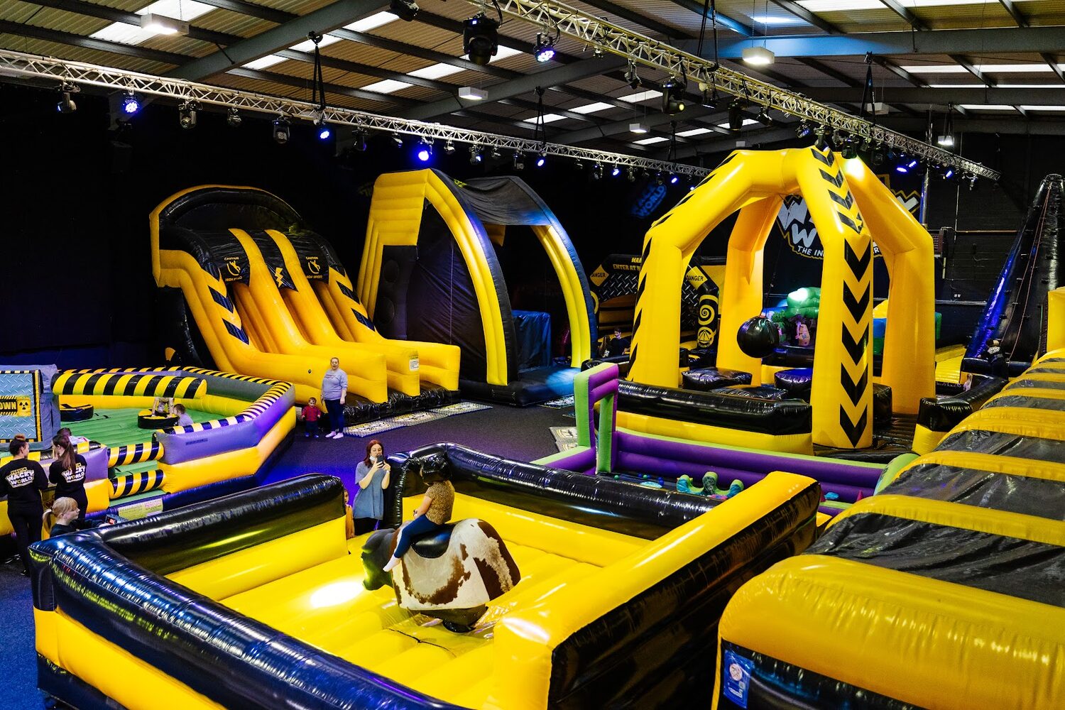 Inside a busy family play centre with big screens