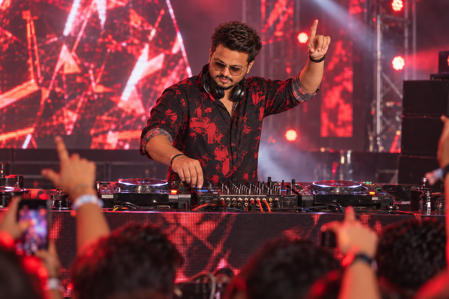Sagar Kadam performing live in a crimson print shirt