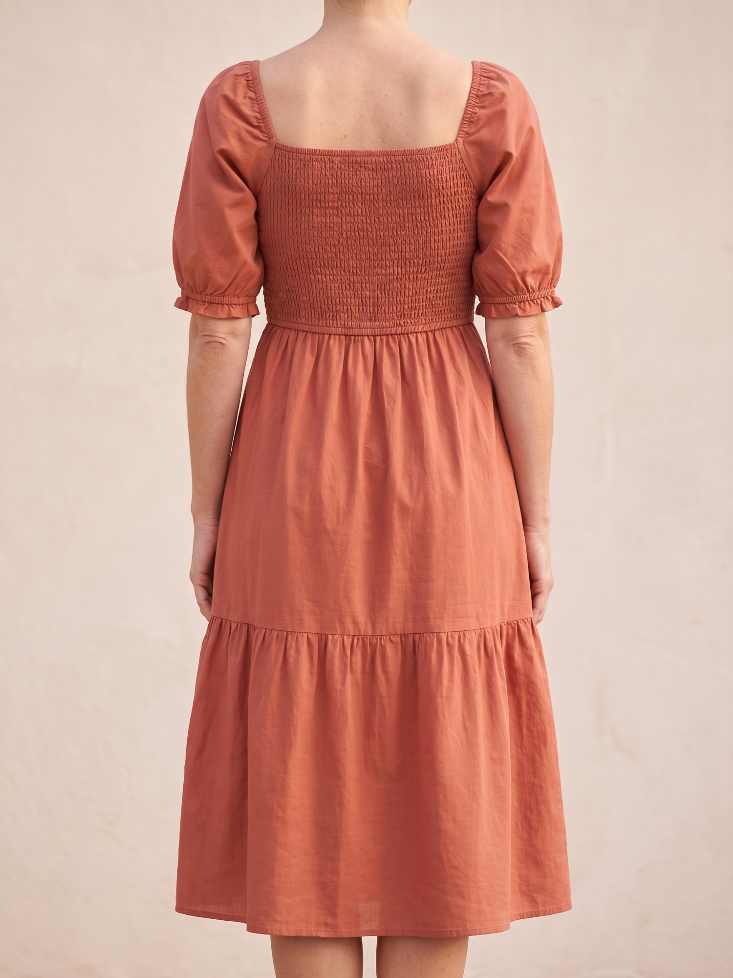 Women's Puff Sleeve Smocked Midi Dress in Terracotta, back view