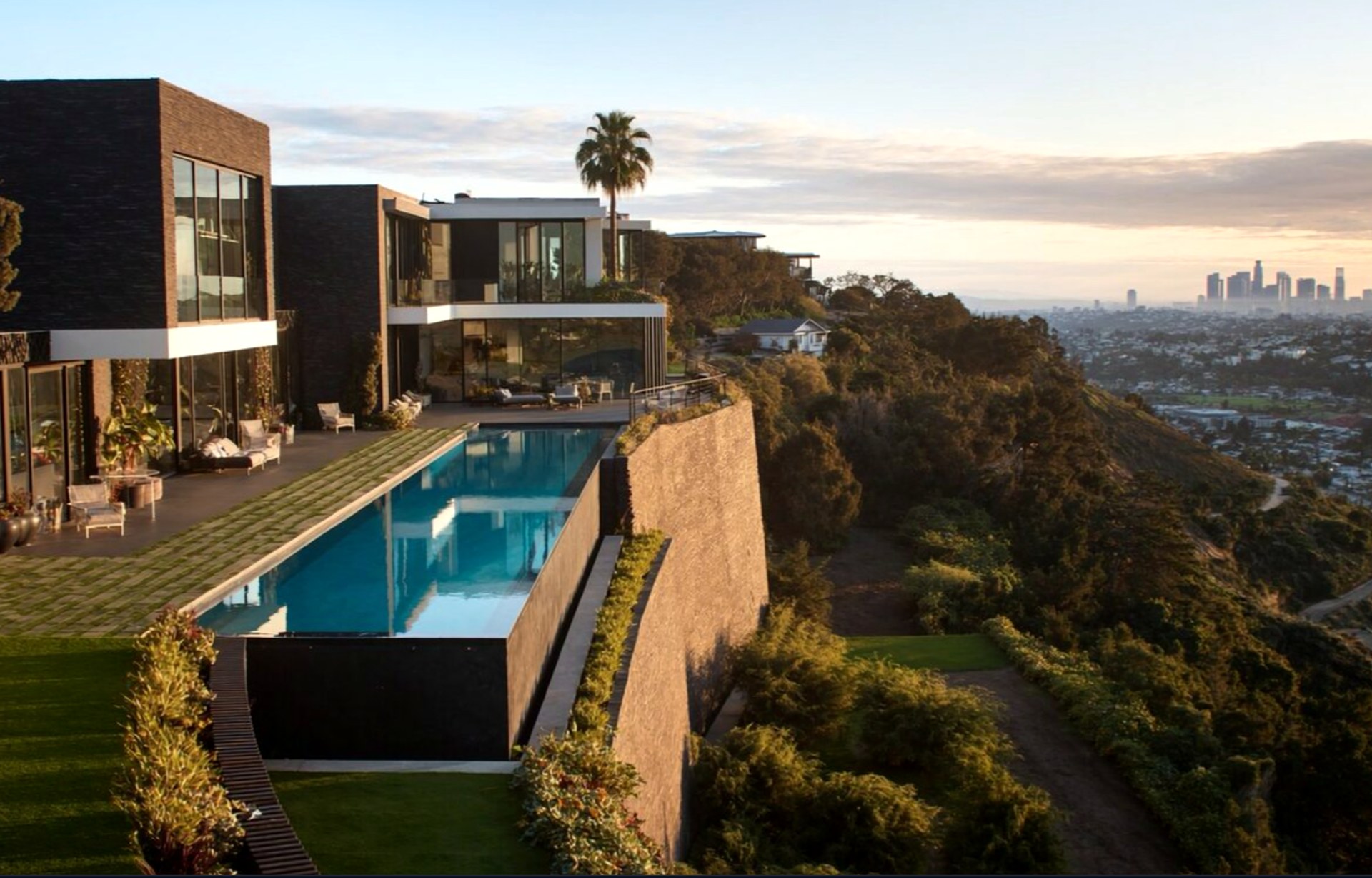 Aerial view of the cliffside modern mansion above the Los Angeles skyline