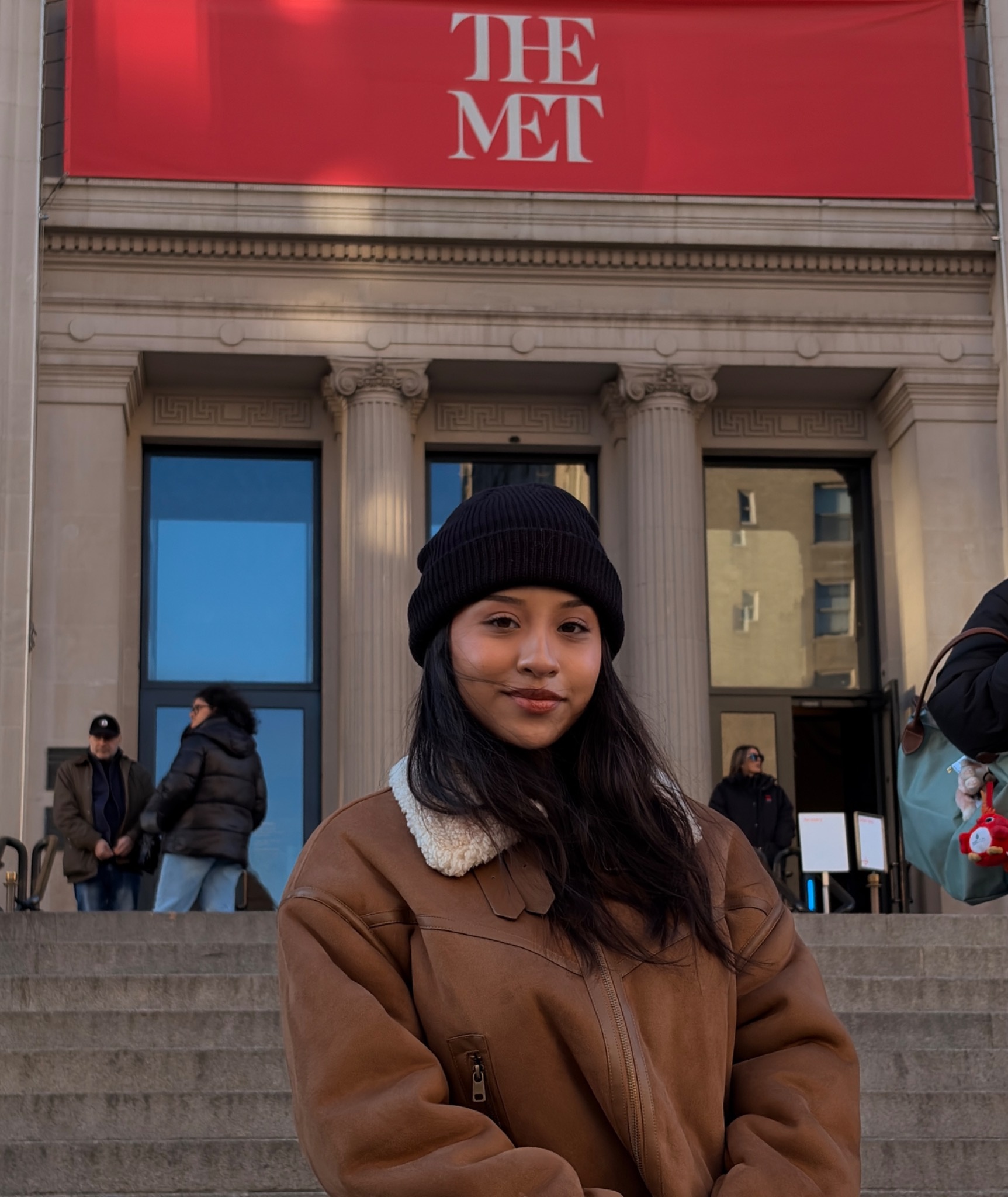 Founder in a brown jacket outside the museum
