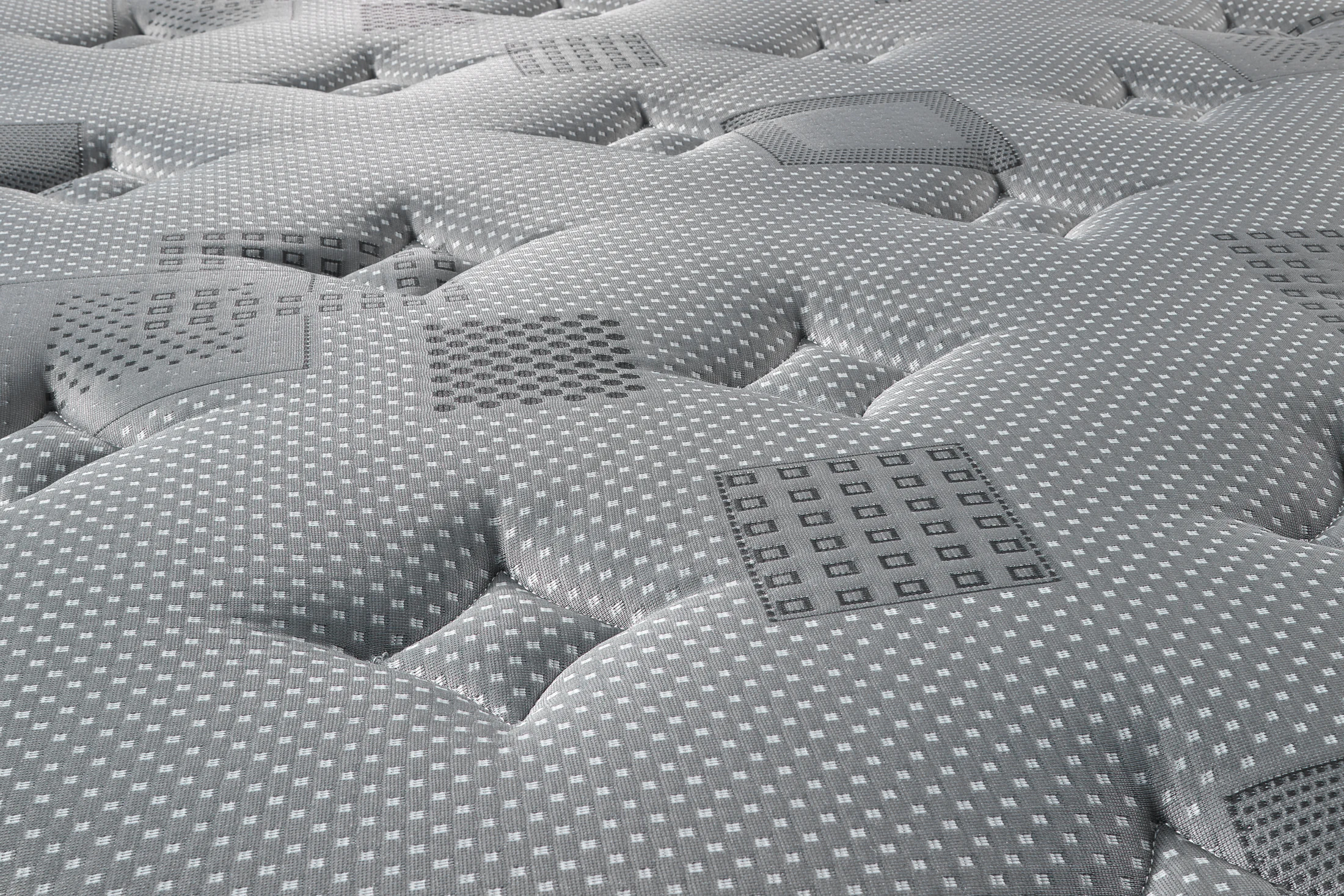 Détail réel du tissu Harmony Charcoal et de la finition du matelas Essentiel