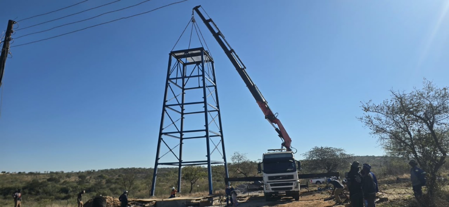 Steel tower being lifted into position