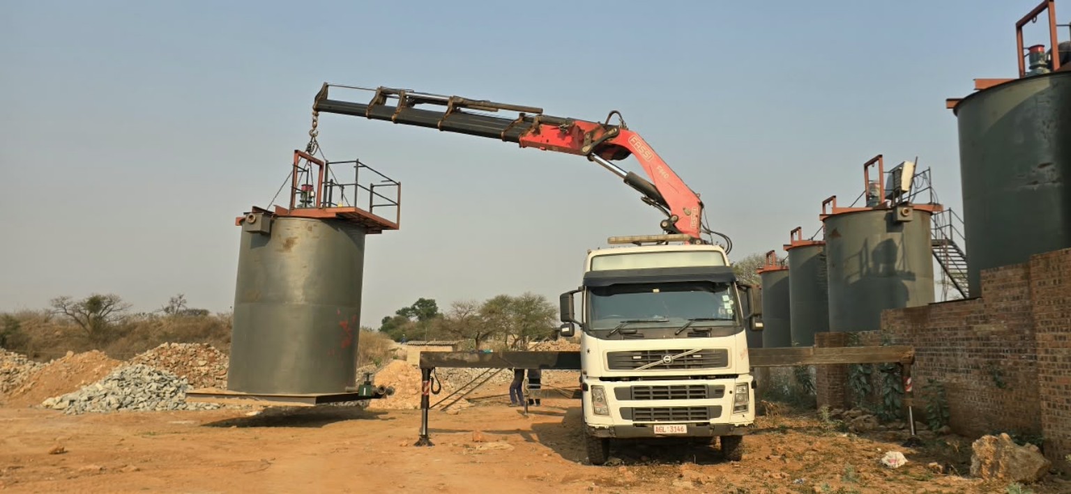 Industrial tanks being positioned by crane