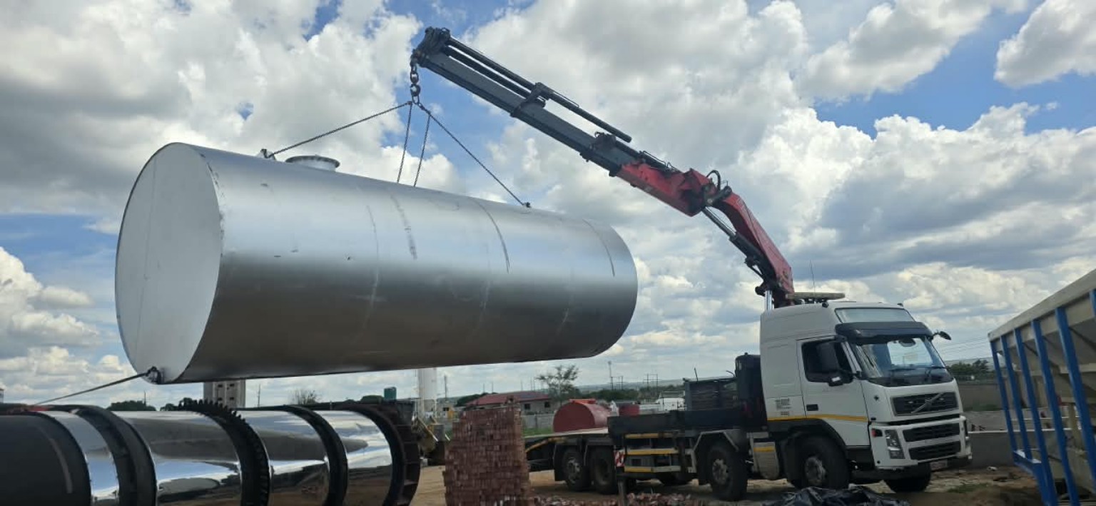 PONK truck-mounted crane lifting an industrial tank